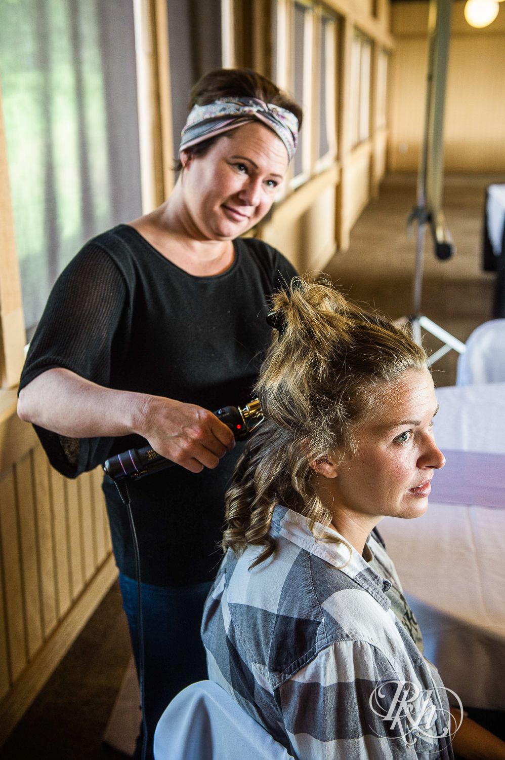 Brides get hair and makeup done before wedding at Spirit Mountain in Duluth, Minnesota.