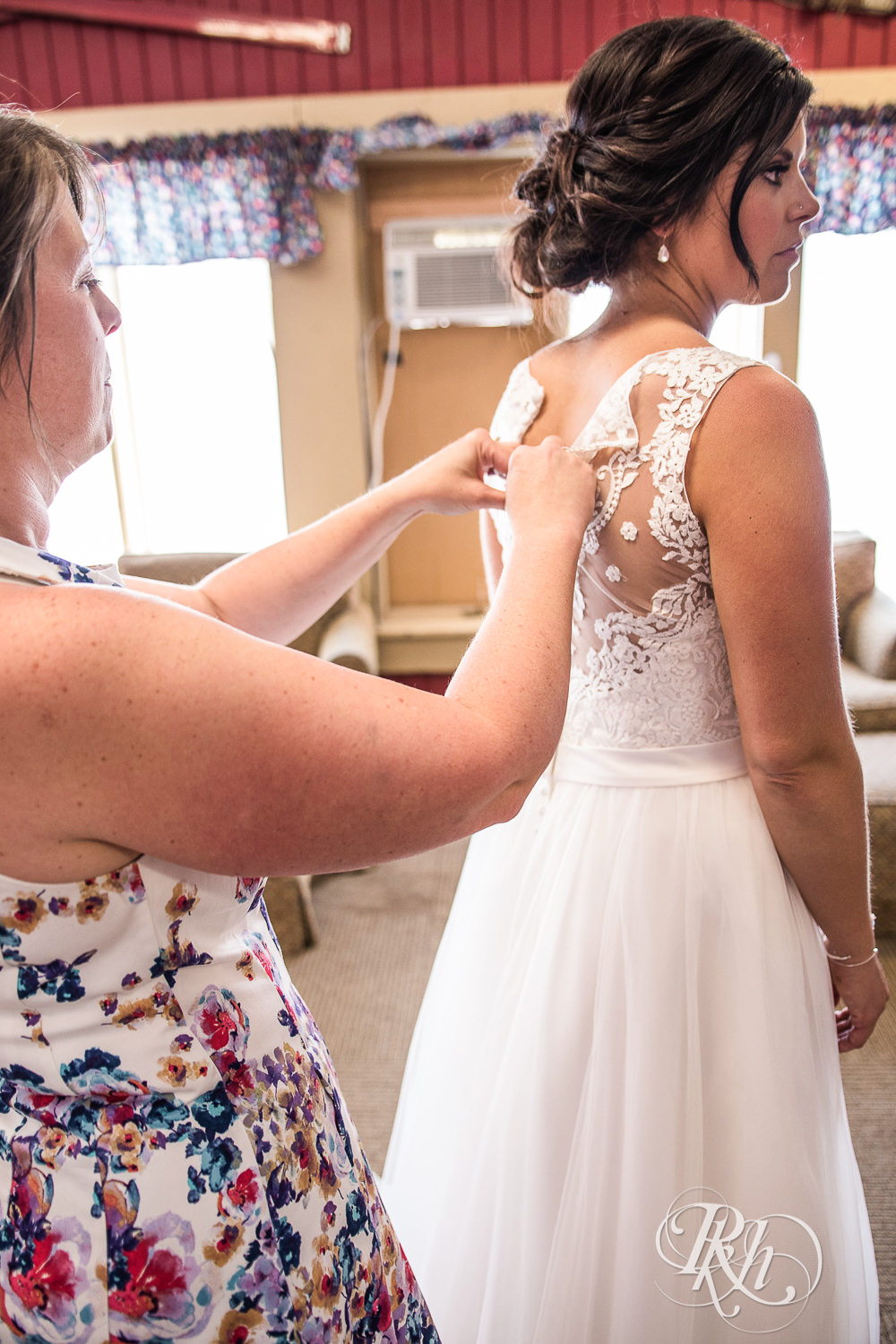 Brides get into dresses before wedding at Spirit Mountain in Duluth, Minnesota.