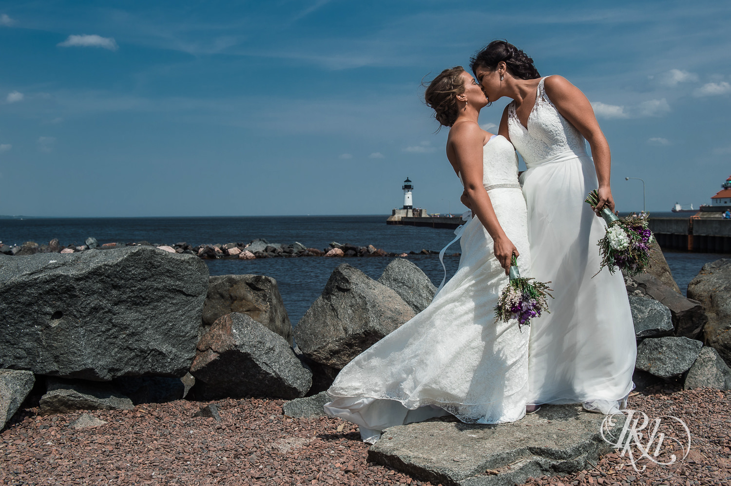 Lesbian brides kiss on the shore of Lake Superior in Duluth, Minnesota.