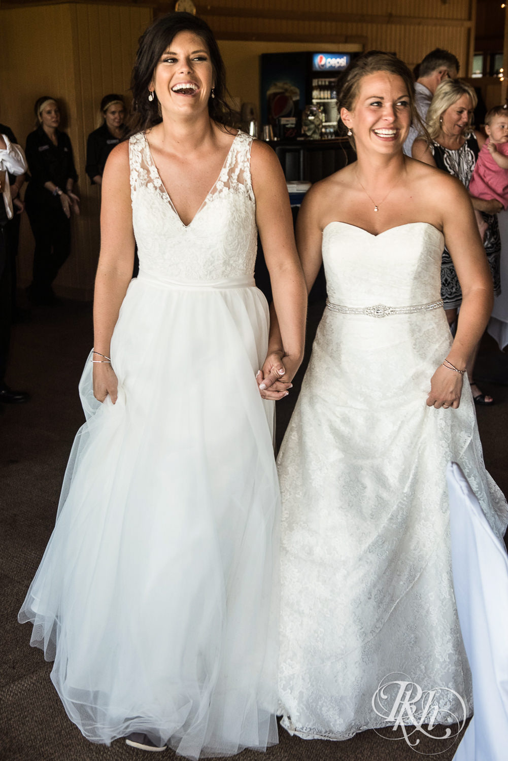 Lesbian brides enter their wedding reception at Spirit Mountain in Duluth, Minnesota.