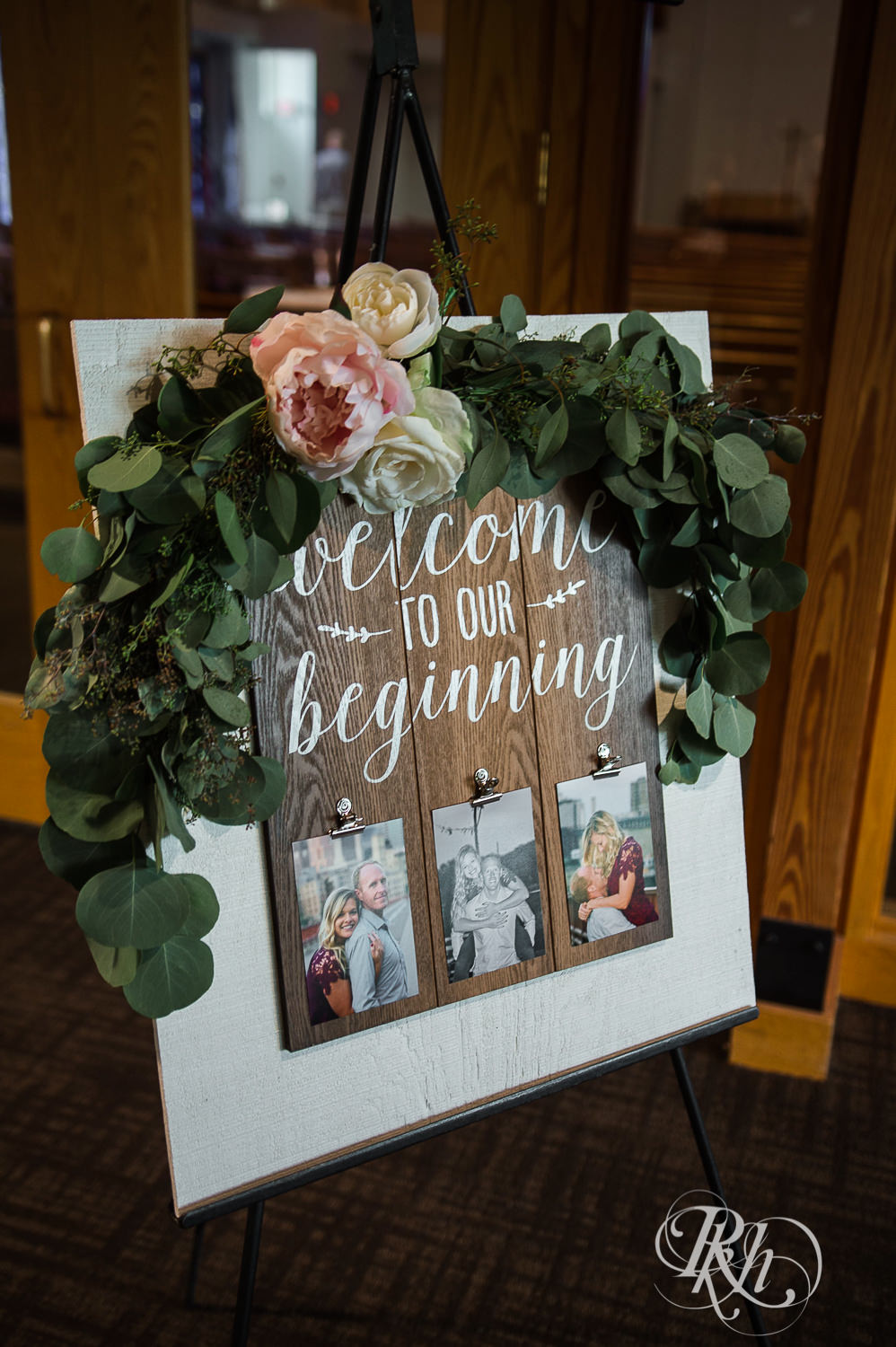 Wedding sign with flowers on top.