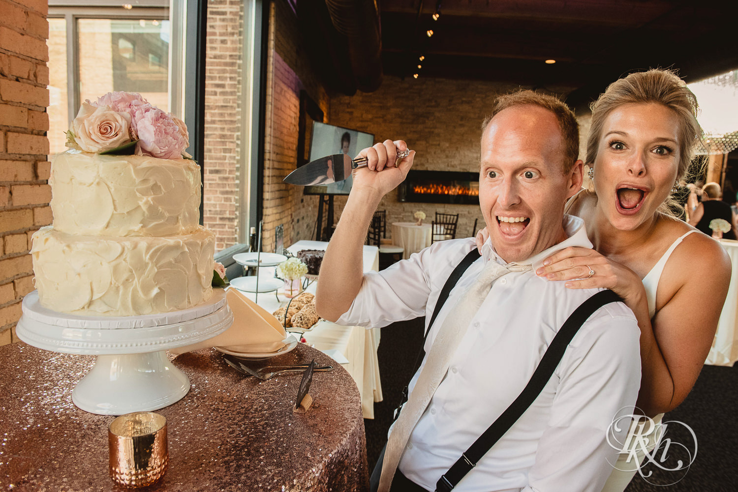 Bride and groom cut wedding cake during wedding reception at Minneapolis Event Centers in Minneapolis, Minnesota.