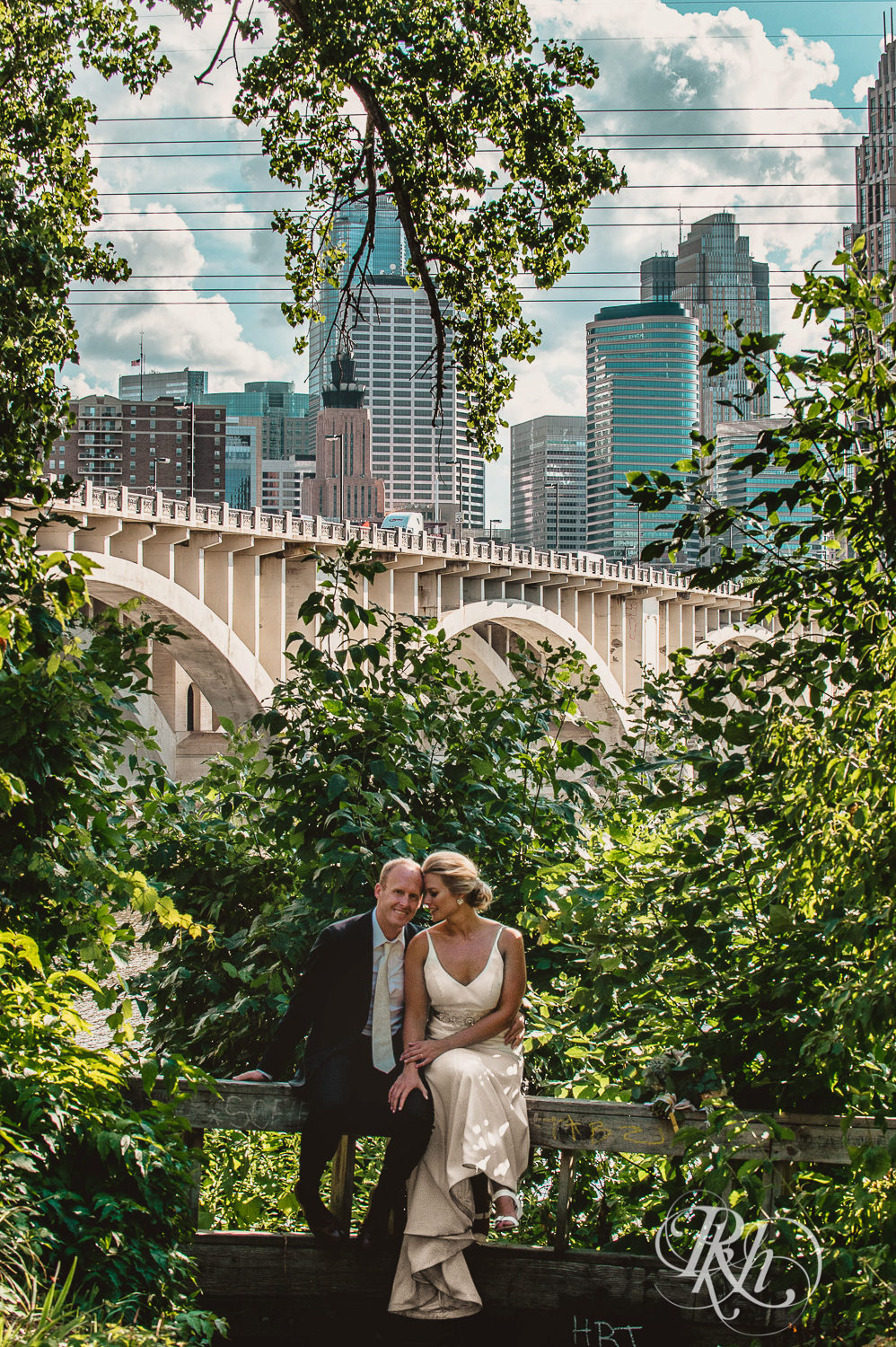 Bride and groom kiss under a bridge on their wedding day in Minneapolis, Minnesota.