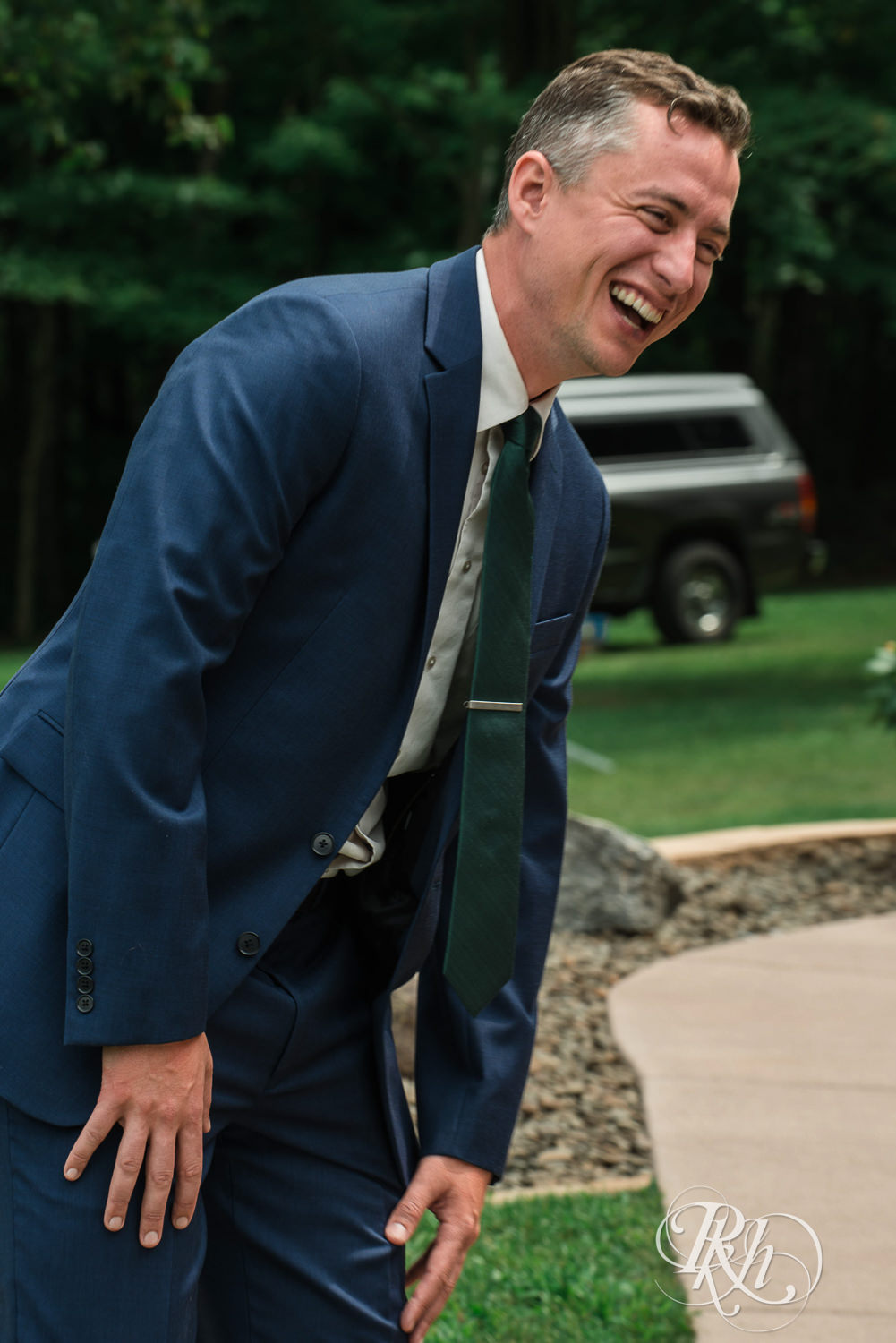Groom laughs during first look on wedding day in Elk Mound, Wisconsin.