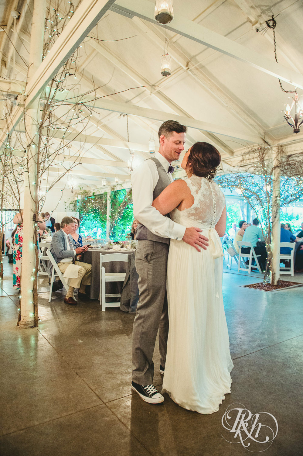 Bride and groom dance during wedding reception at Camrose Hill Flower Farm in Stillwater, Minnesota.