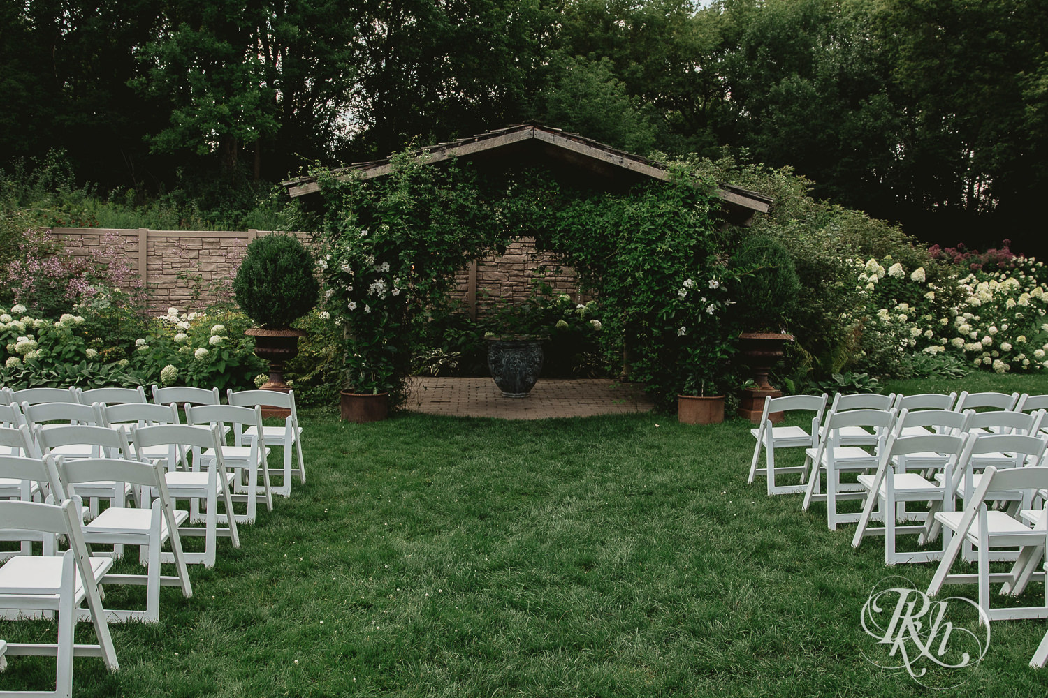 Outdoor summer wedding ceremony setup at Camrose Hill Flower Farm in Stillwater, Minnesota.