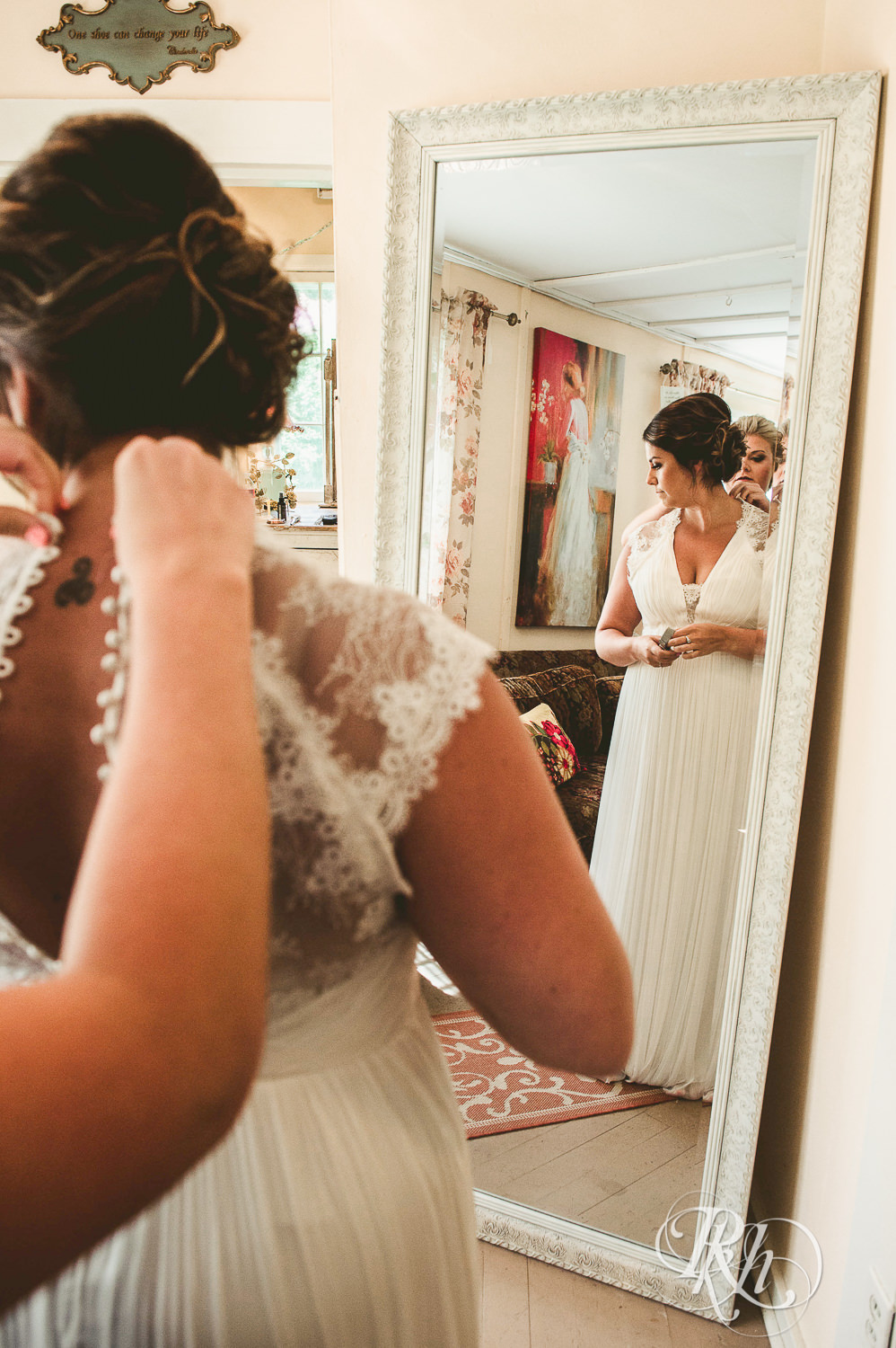 Bride standing in front of mirror at Camrose Hill Flower Farm in Stillwater, Minnesota.