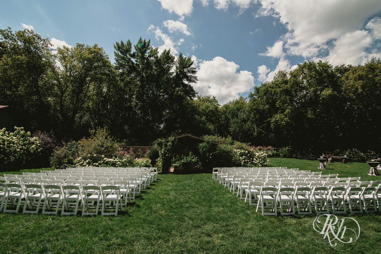 Outdoor summer wedding ceremony setup at Camrose Hill Flower Farm in Stillwater, Minnesota.
