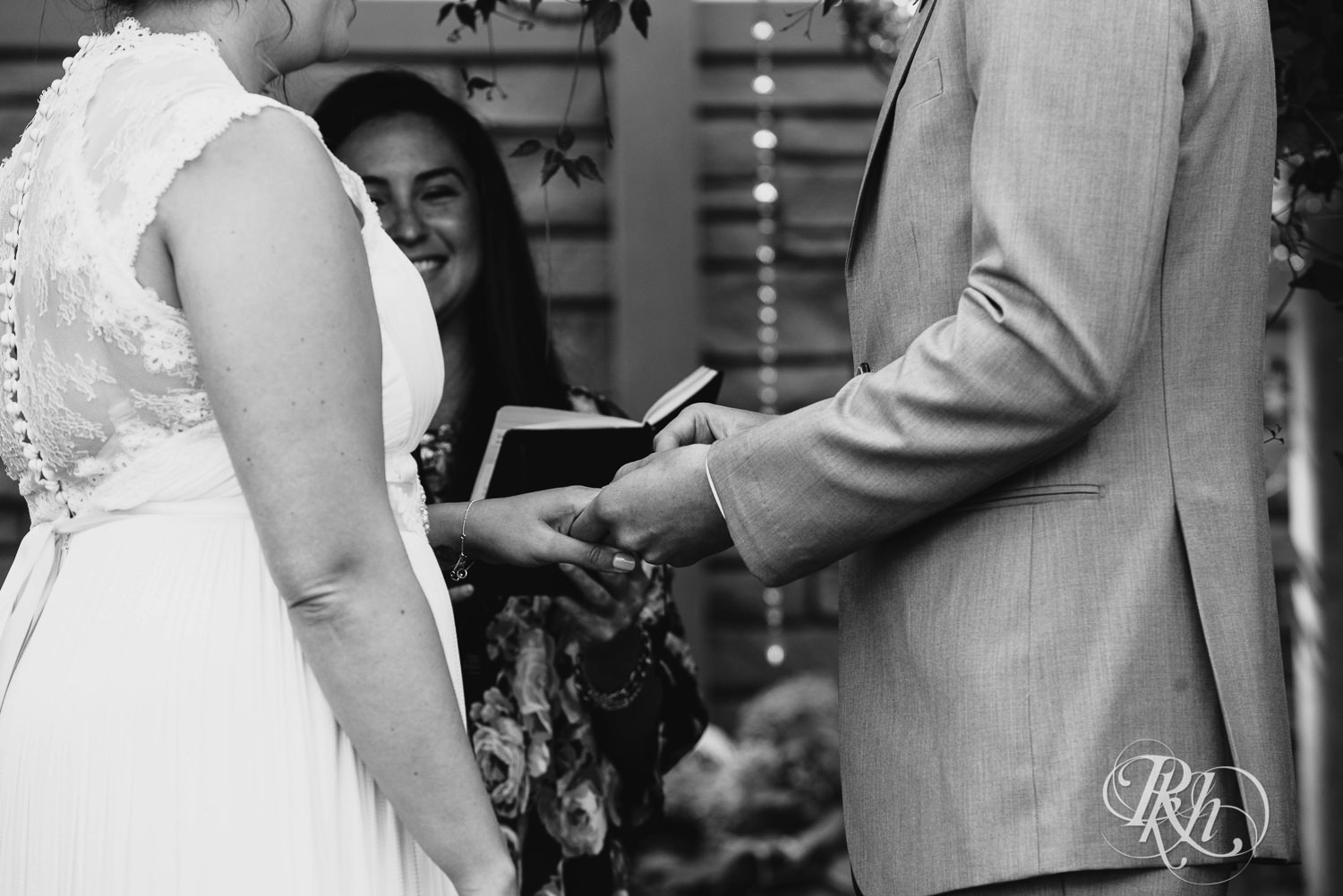 Bride and groom exchange rings during wedding ceremony at Camrose Hill Flower Farm in Stillwater, Minnesota.