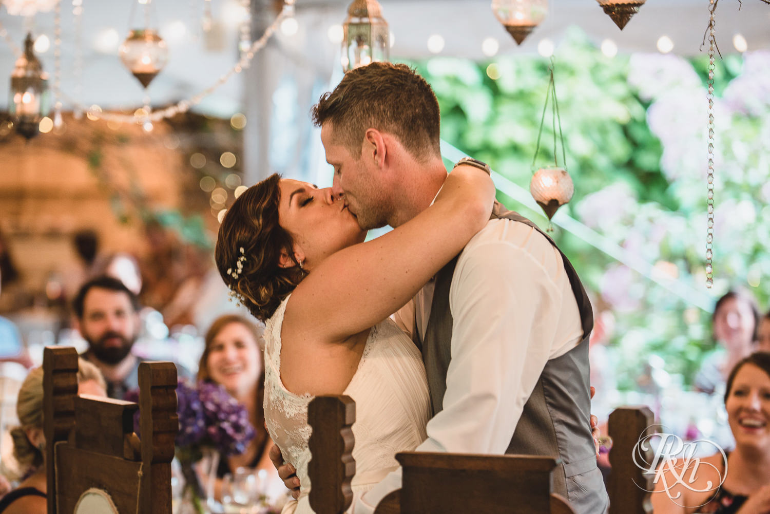 Bride and groom kiss during reception at Camrose Hill Flower Farm in Stillwater, Minnesota.