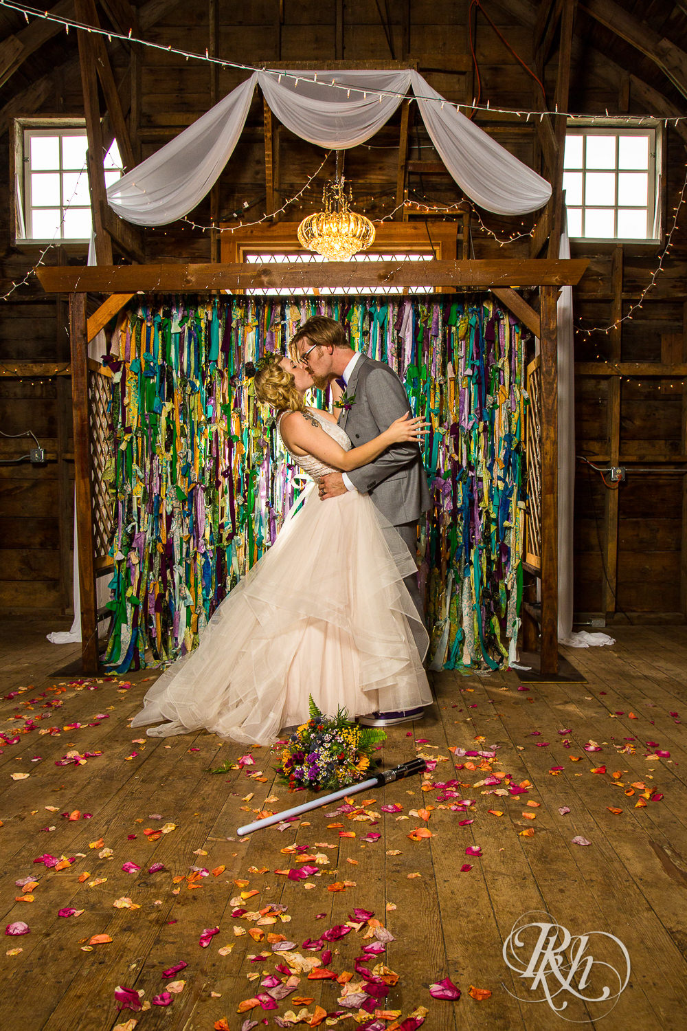 Bride and groom kiss at Coops Event Barn in Dodge Center, Minnesota.