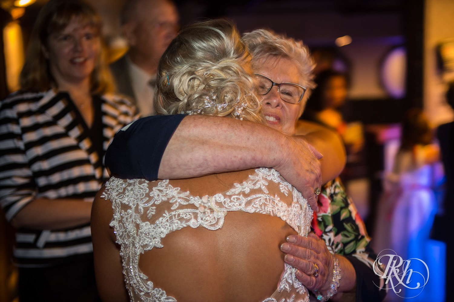 Bride and groom hug guests at the Lumber Exchange Event Center in Minneapolis, Minnesota.