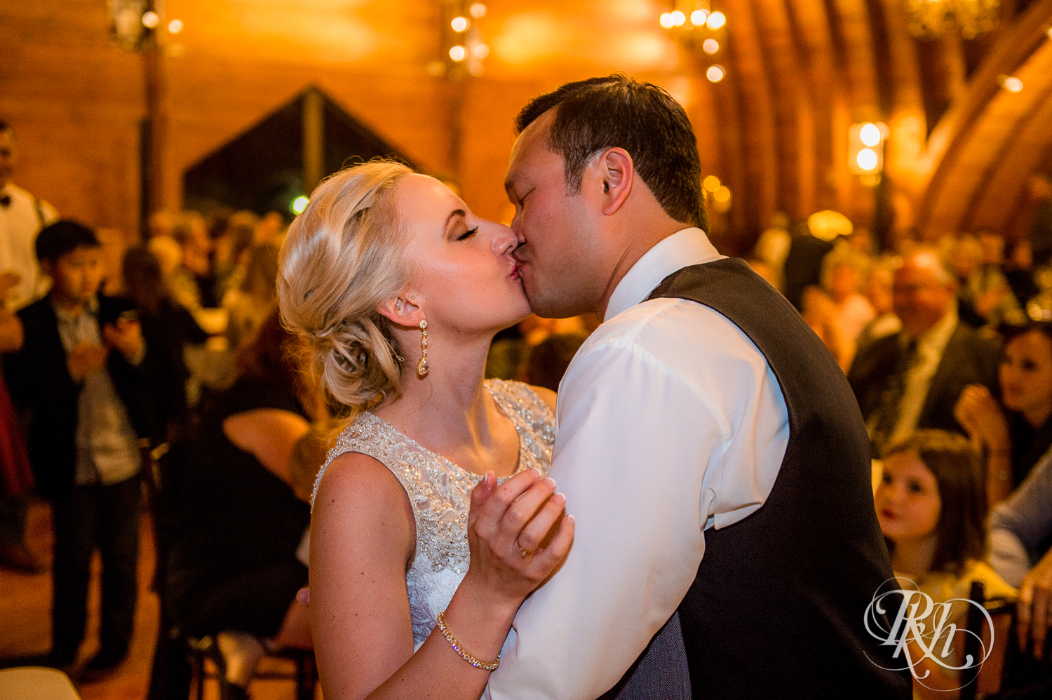 Bride and groom kiss at Green Acres Event Center barn wedding in Eden Prairie, Minnesota.