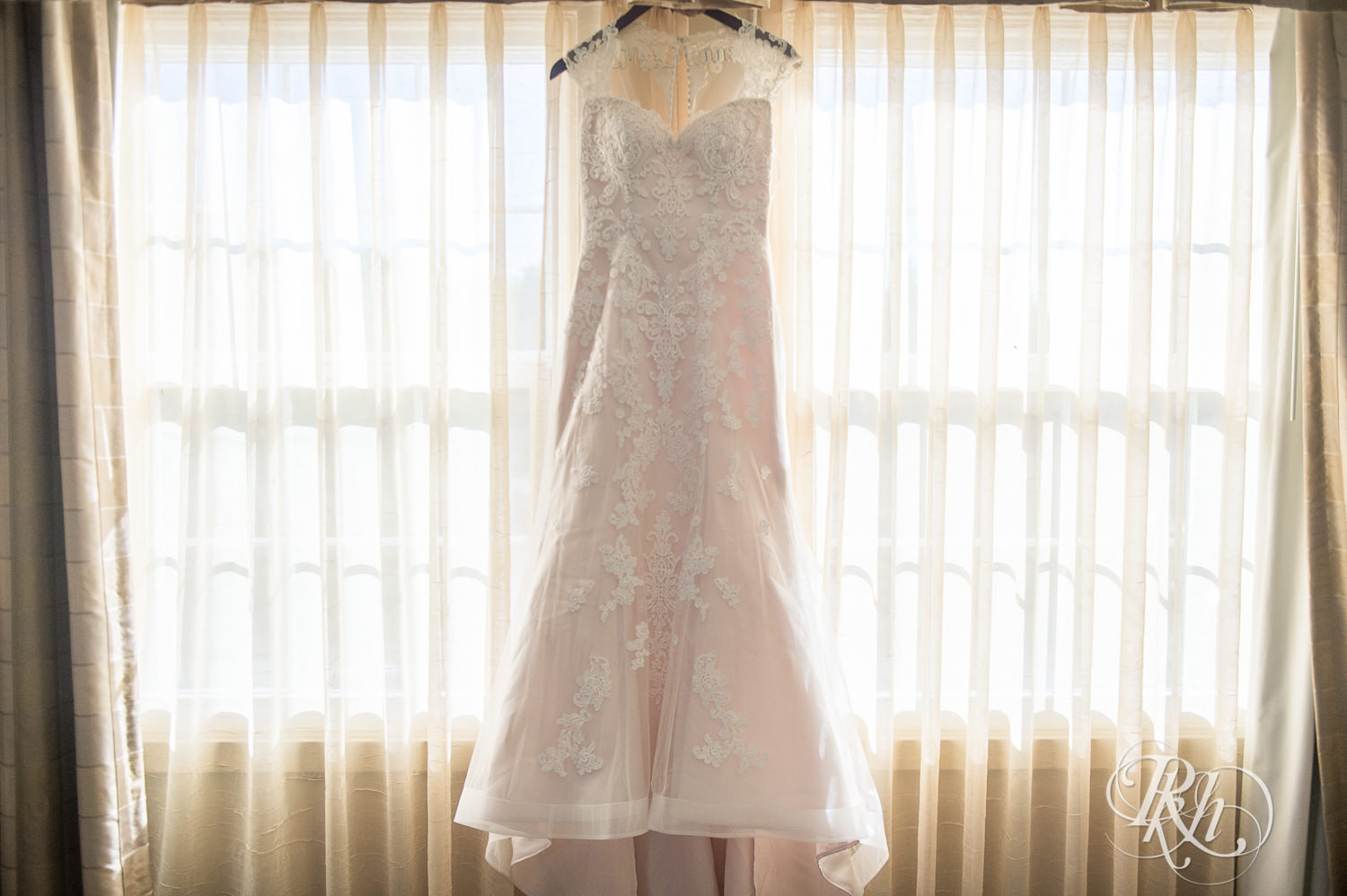 Wedding dress hanging in window in White Bear Lake, Minnesota.
