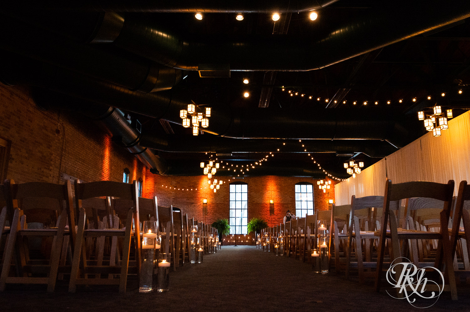 Indoor wedding ceremony setup at Nicollet Island Pavilion in Minneapolis, Minnesota. 