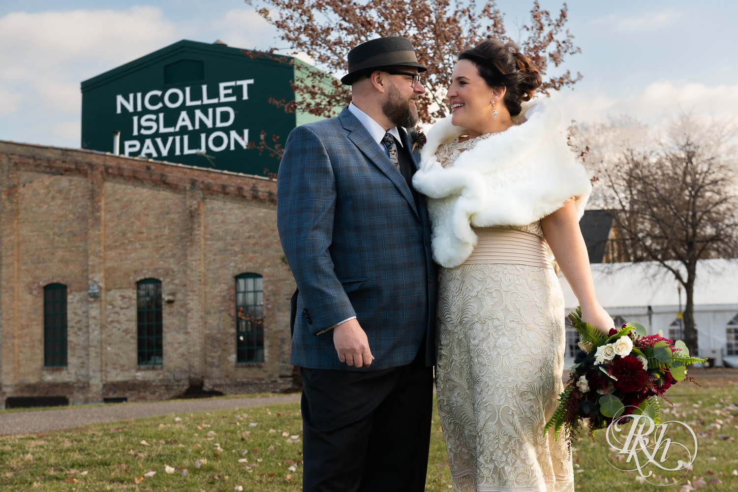 Bride and groom stand outside Nicollet Island Pavilion on their wedding day.