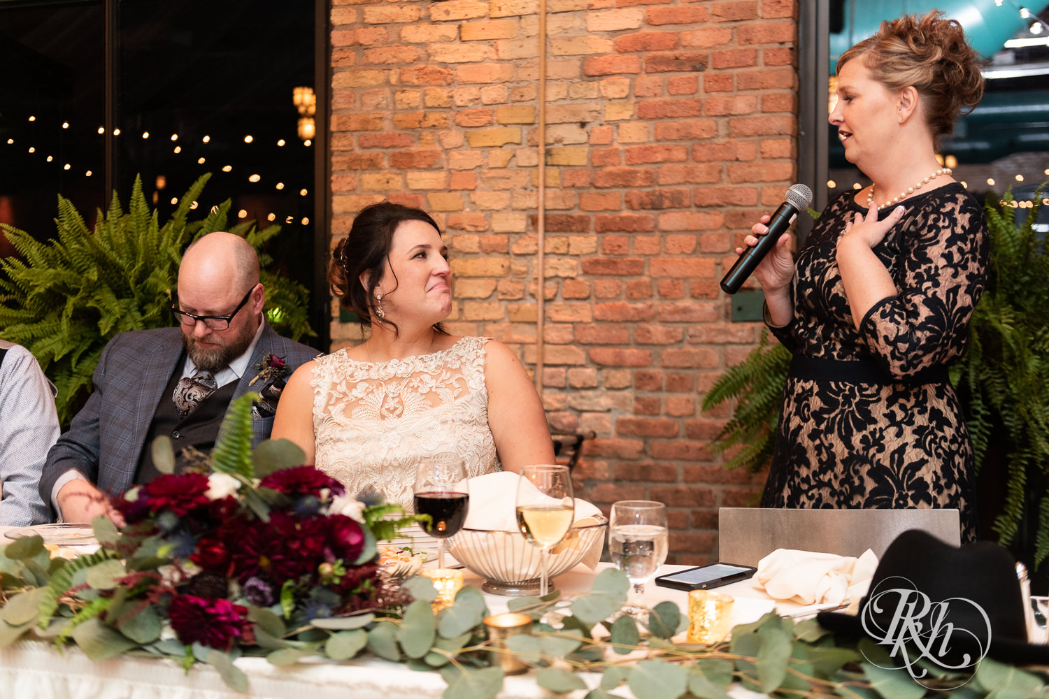 Bride and groom tear up during wedding reception at Nicollet Island Pavilion in Minneapolis, Minnesota.