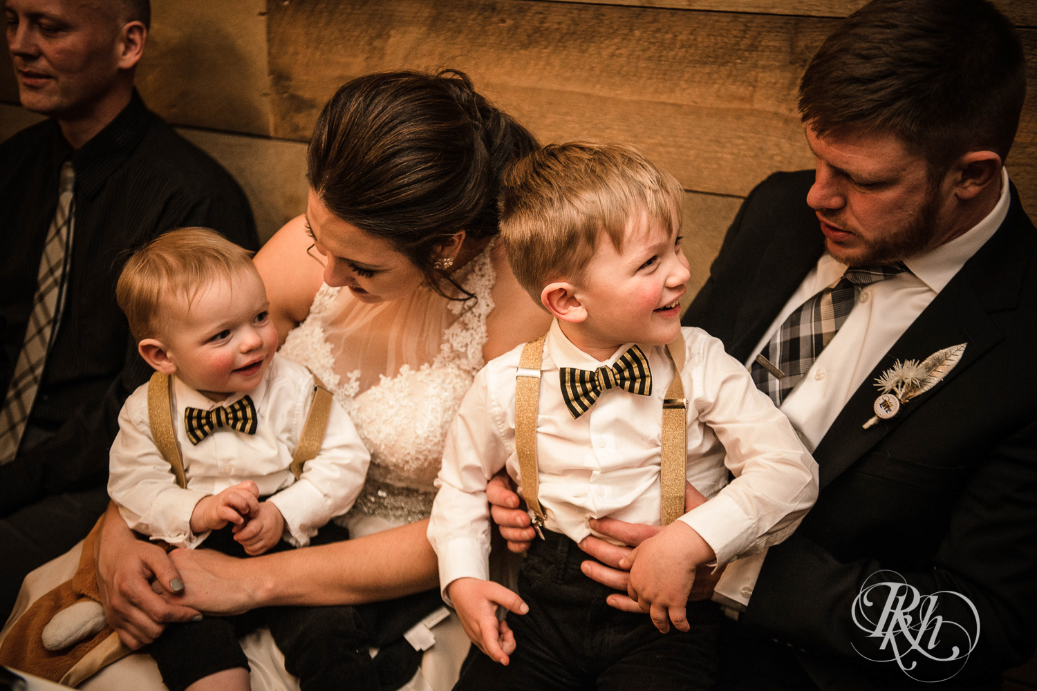 Bride and groom get caricature during wedding reception with their sons at Creekside Farm in Rush City, Minnesota.