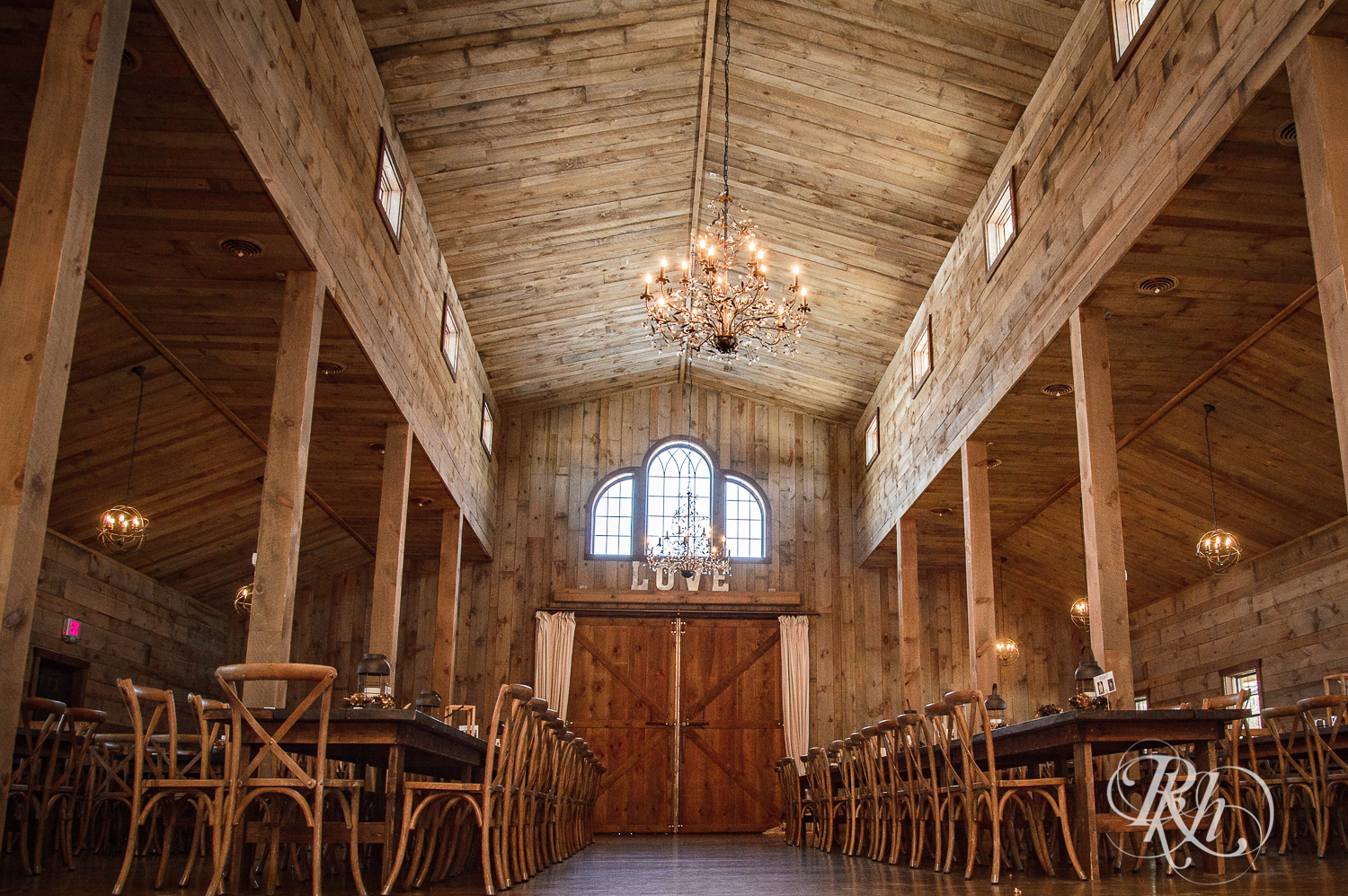 Indoor wedding ceremony and reception setup at Creekside Farm in Rush City, Minnesota.