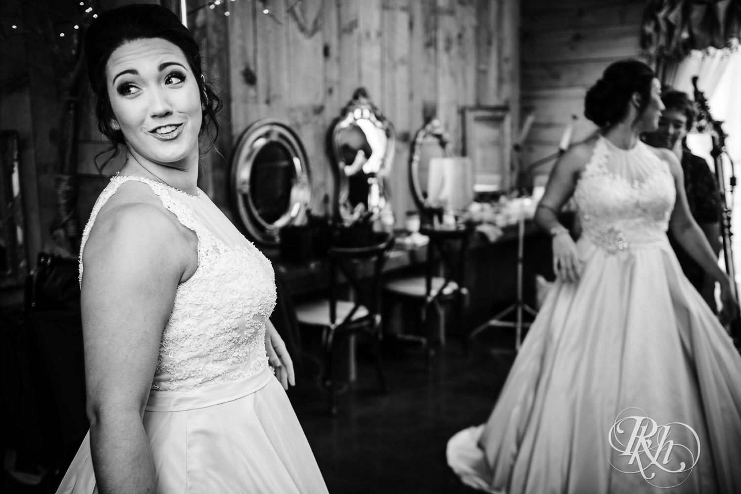 Bride gets into wedding dress before wedding at Creekside Farm in Rush City, Minnesota.