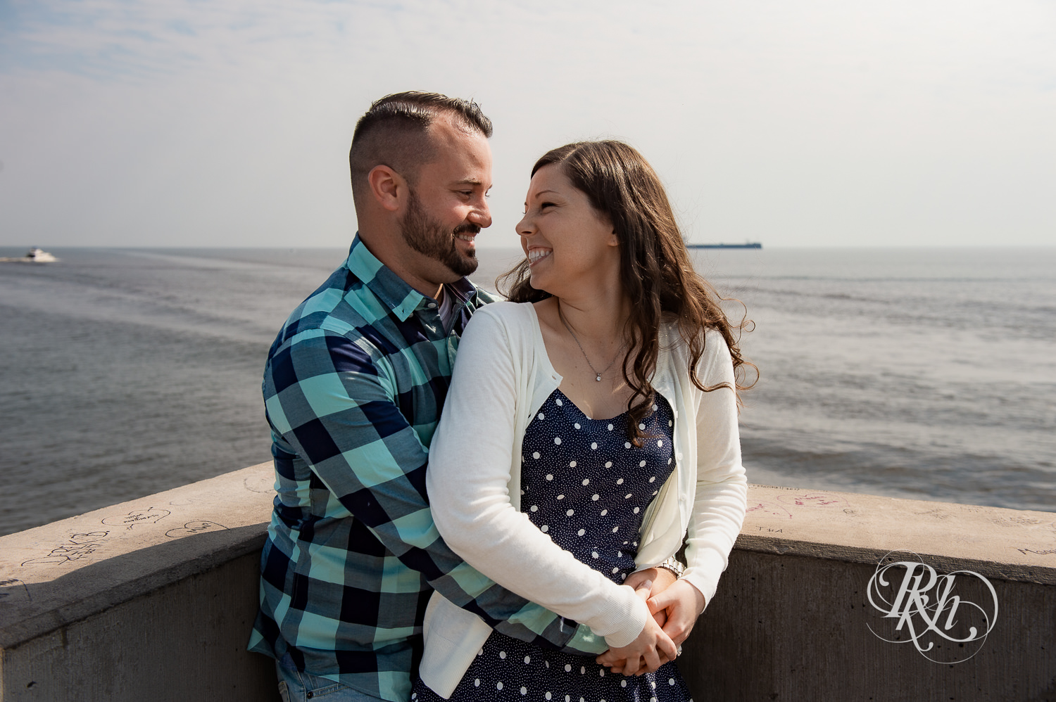 Man and woman laugh with Lake Superior in the background in Duluth, Minnesota.