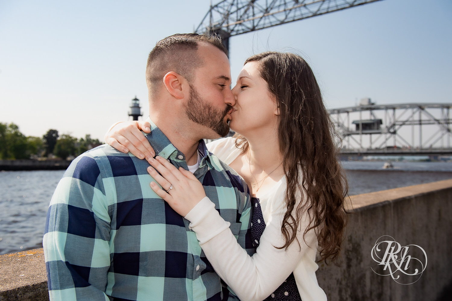 Man and woman kiss with Lake Superior in the background in Duluth, Minnesota.