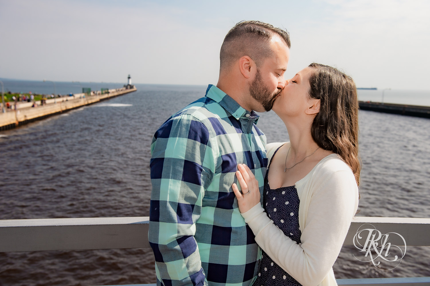 Man and woman kiss with Lake Superior in the background in Duluth, Minnesota.
