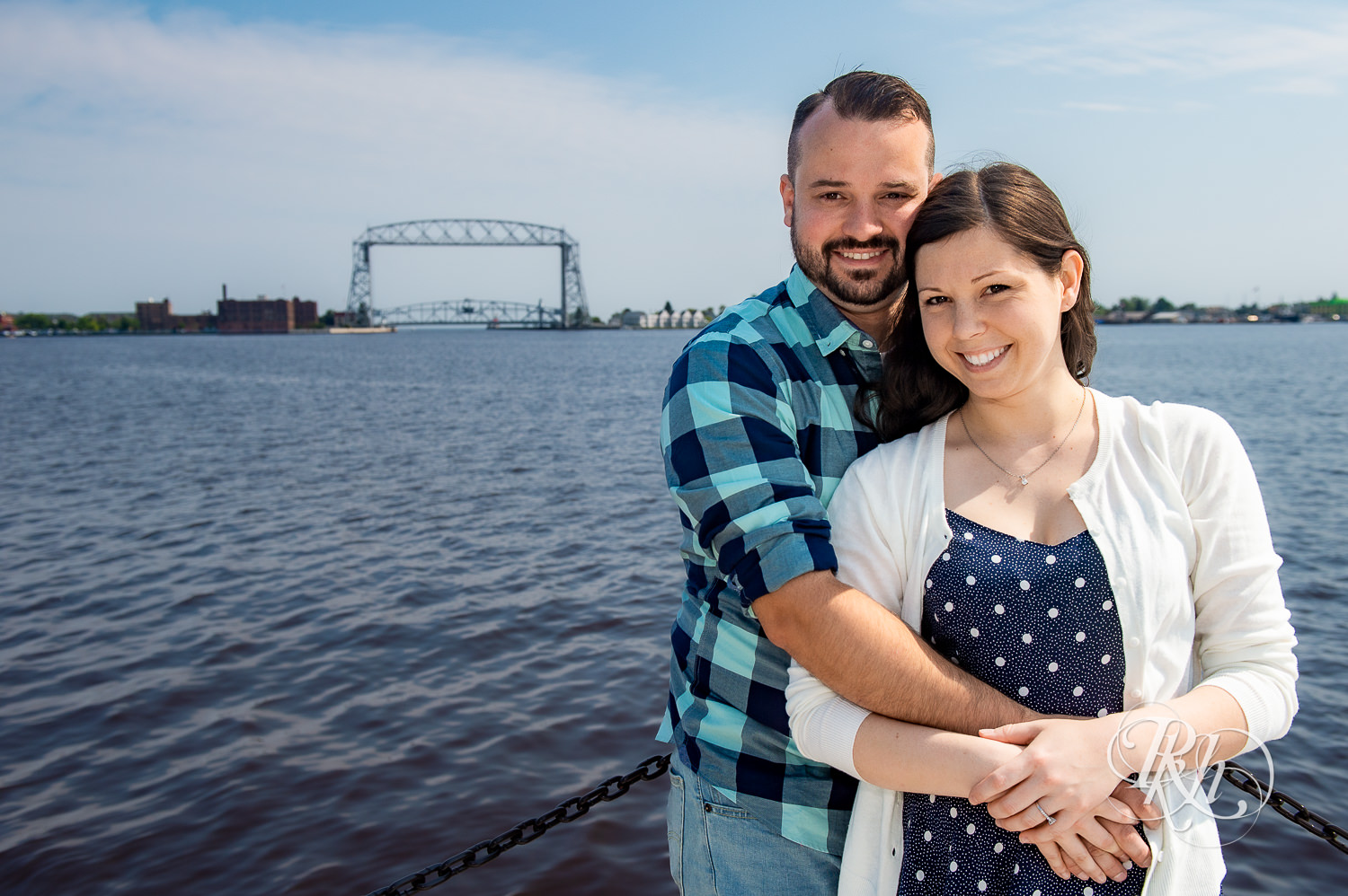 Man and woman smile in front of Lake Superior in Canal Park in Duluth, Minnesota.