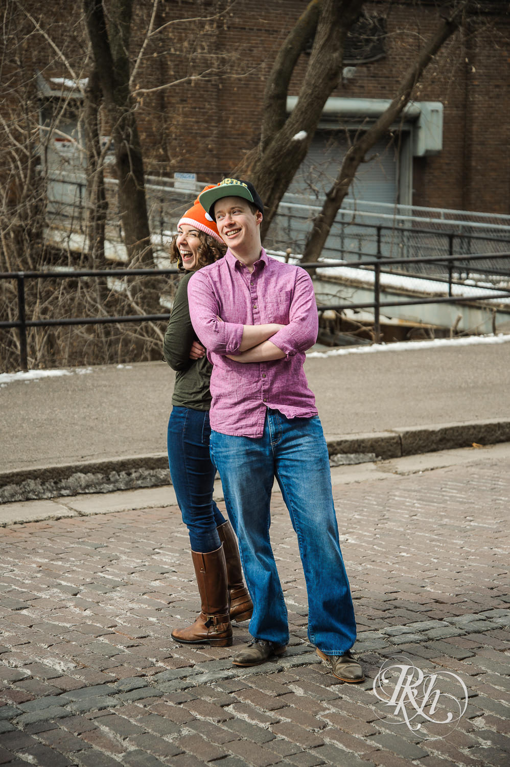 Man and woman laugh in the road wearing Pokemon hats in Minneapolis, Minnesota.