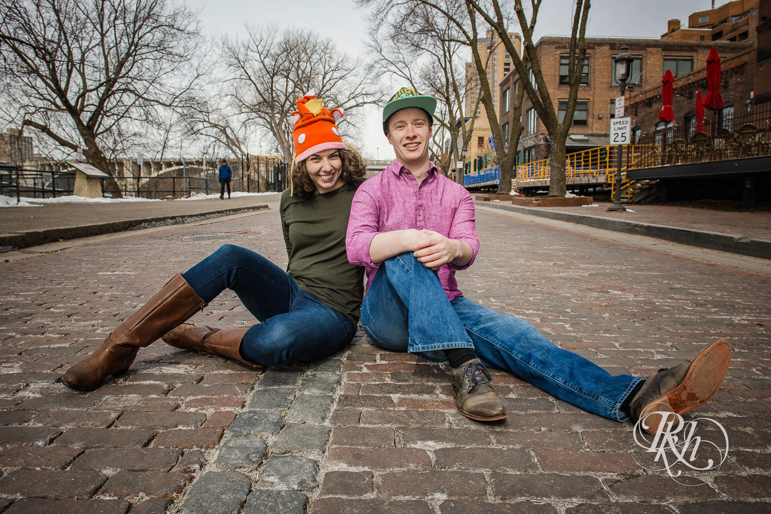 Man and woman laugh in the road wearing Pokemon hats in Minneapolis, Minnesota.