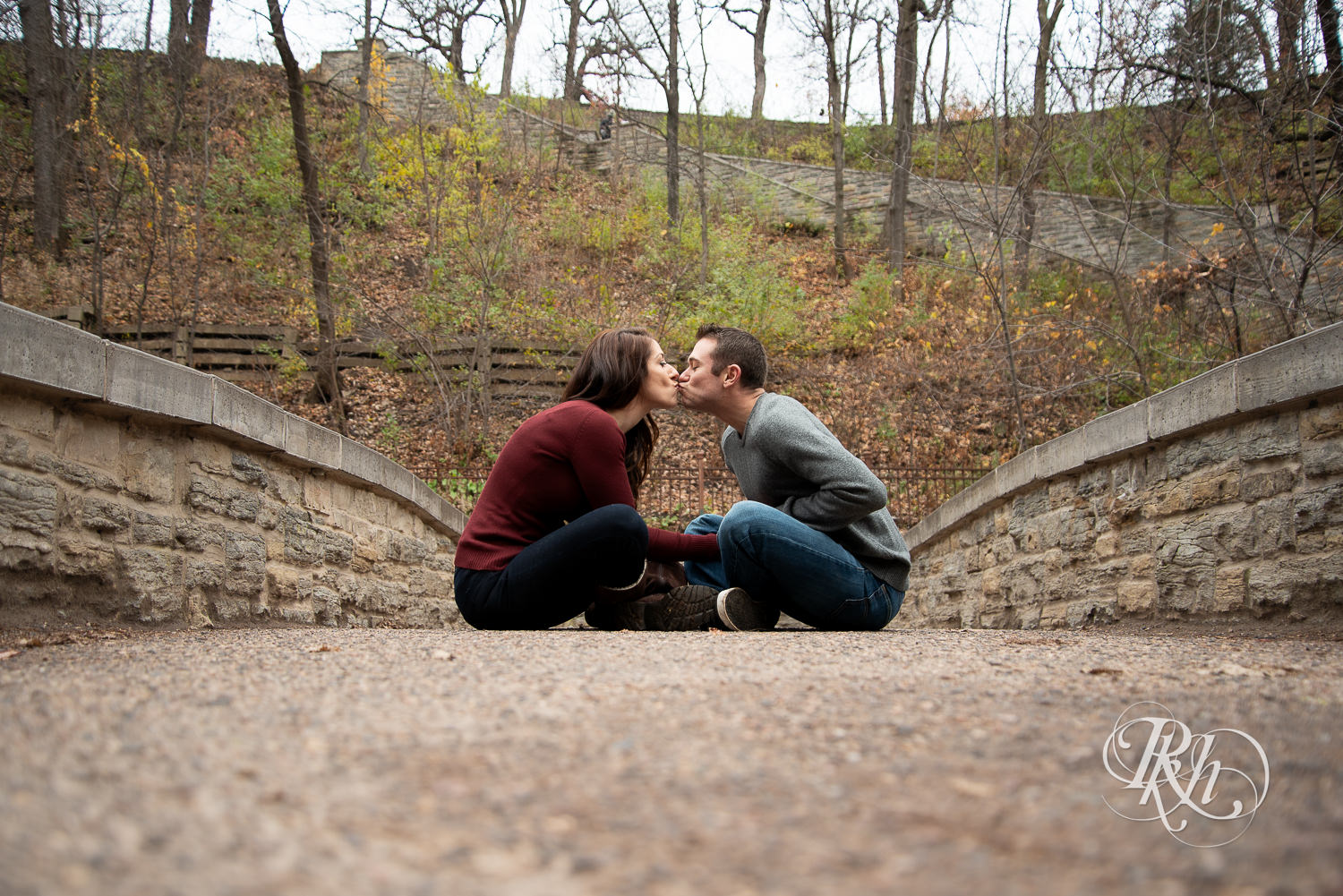 Man and woman kiss in Minnehaha Falls in Minneapolis, Minnesota.