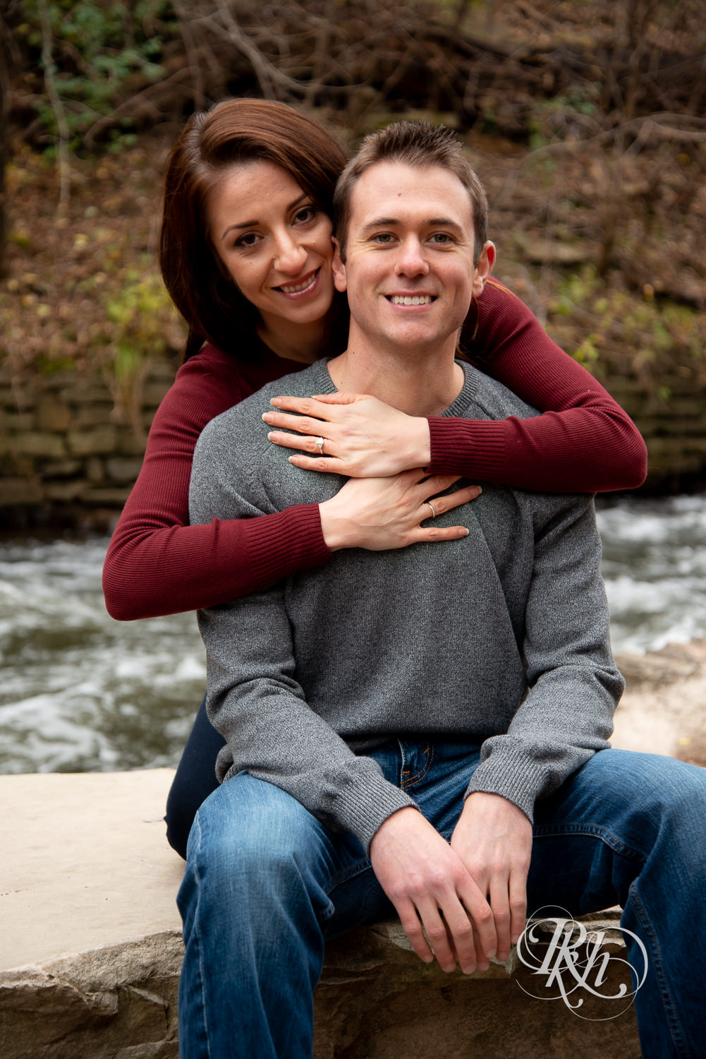 Man and woman smile in Minnehaha Falls in Minneapolis, Minnesota.