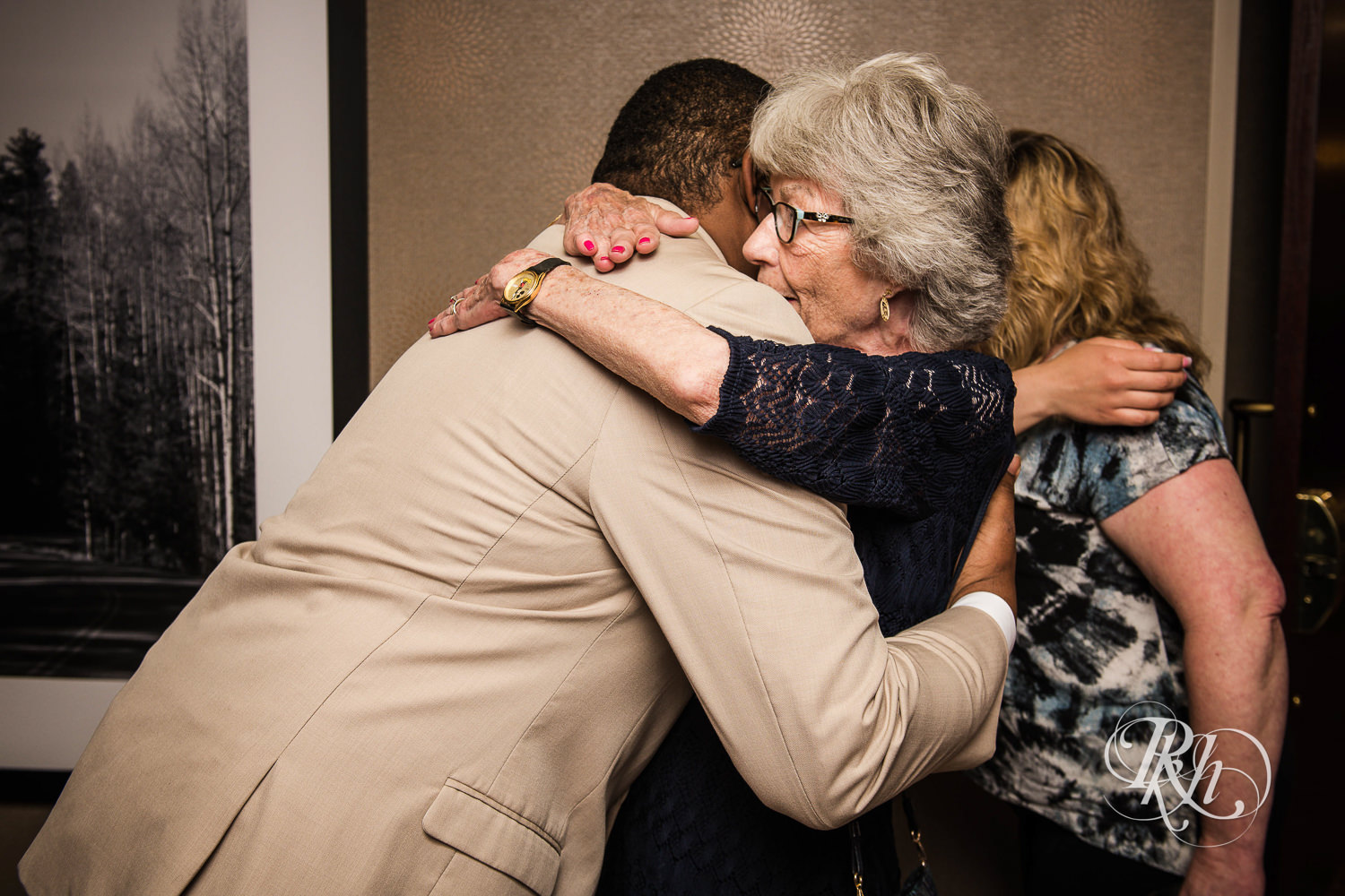 Guests hug groom after wedding ceremony at North Metro Event Center in Shoreview, Minnesota.