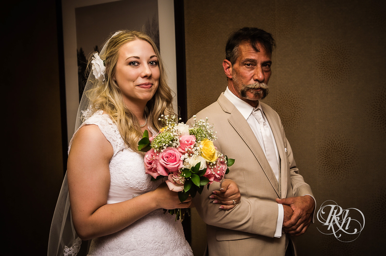 Bride smiles with dad before wedding ceremony at North Metro Event Center in Shoreview, Minnesota.
