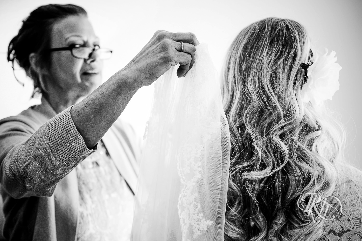 Bride getting buttoned into dress before the wedding at North Metro Event Center in Shoreview, Minnesota.