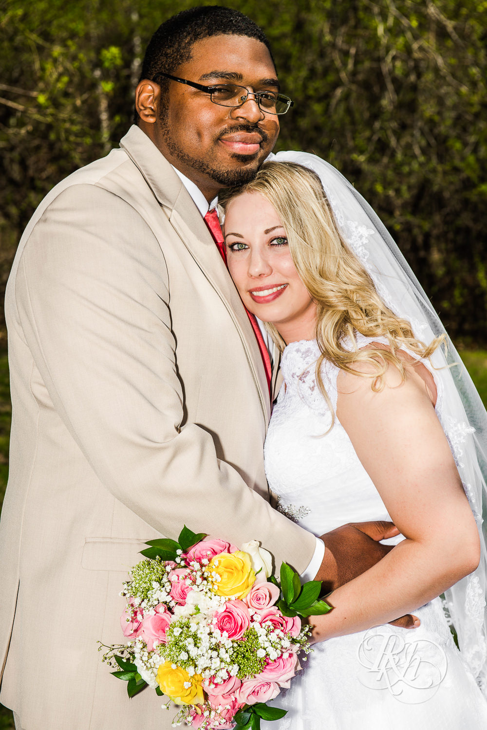 White bride and black groom smile during at North Metro Event Center wedding in Shoreview, Minnesota.