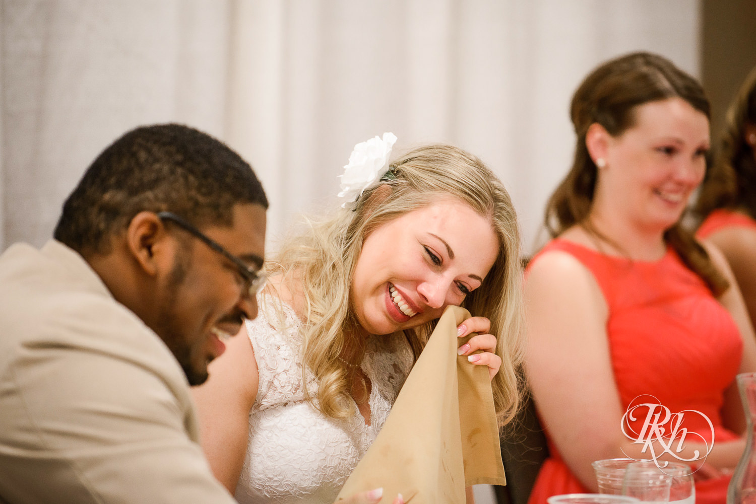 White bride and black groom smile during wedding reception at North Metro Event Center in Shoreview, Minnesota.