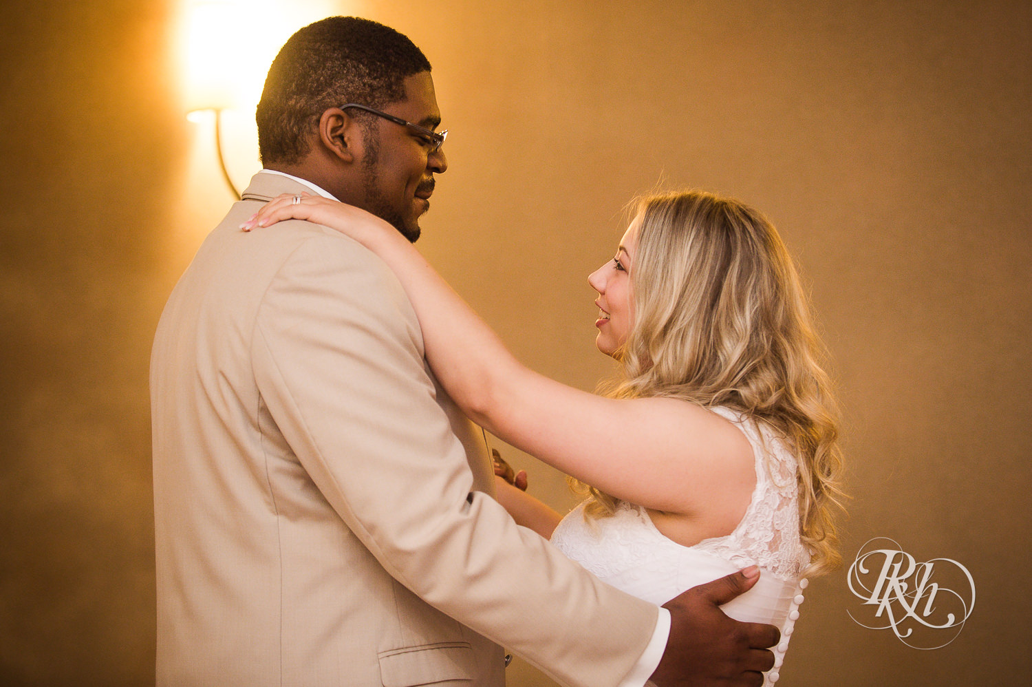 White bride and black groom dance during wedding reception at North Metro Event Center in Shoreview, Minnesota.