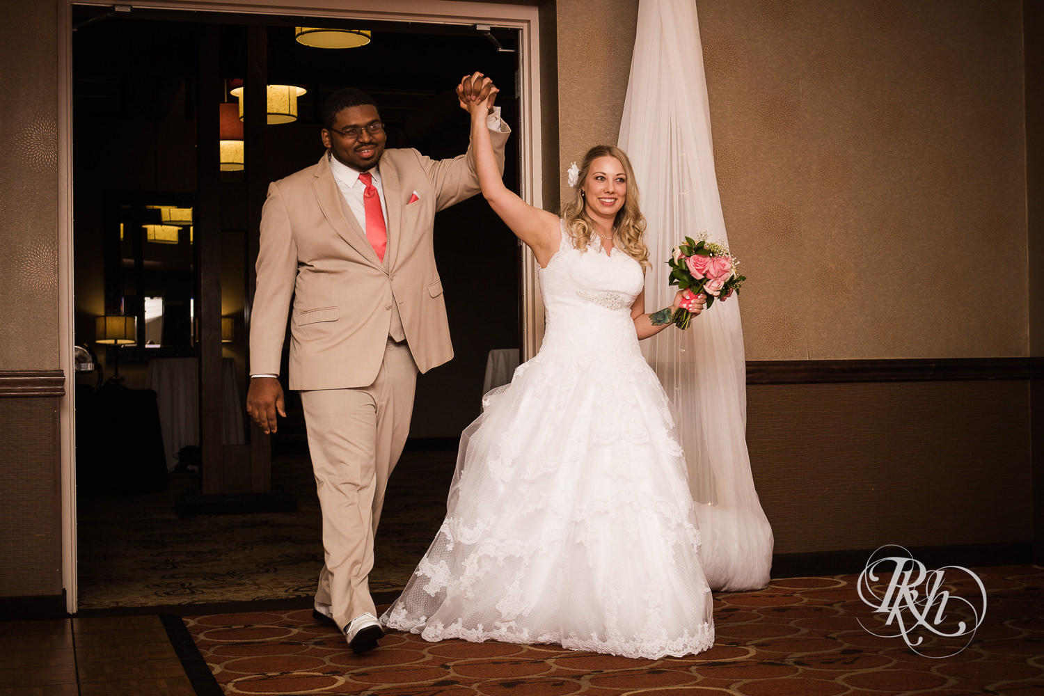 White bride and black groom enter wedding reception at North Metro Event Center in Shoreview, Minnesota.