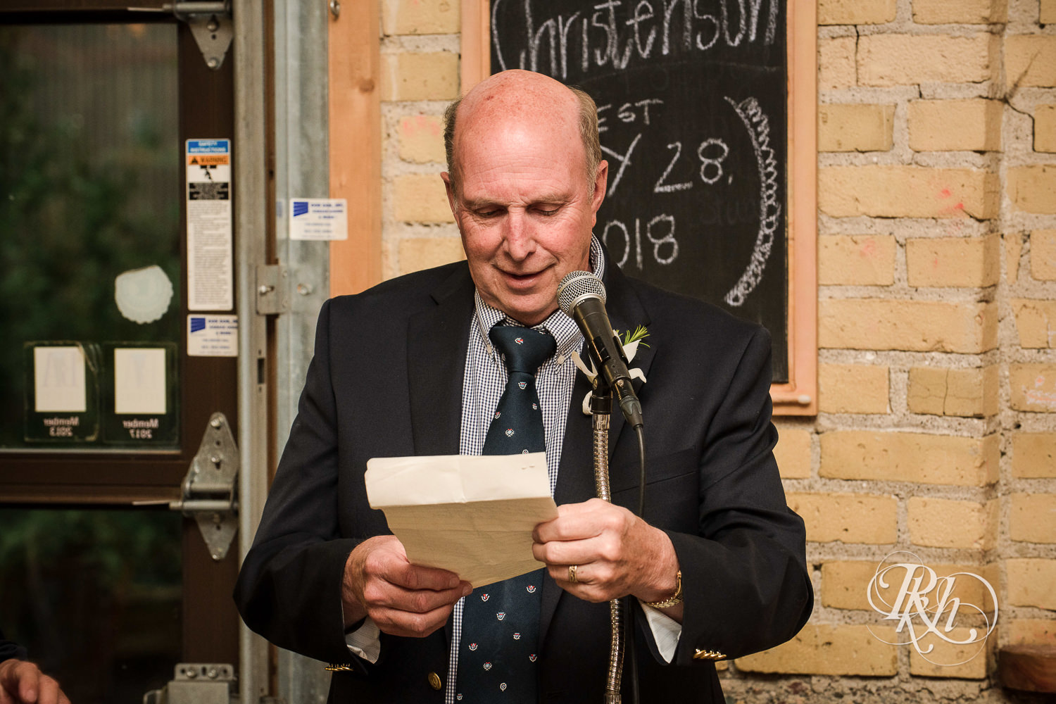 Dad smiles during wedding speeches at 612 Brew in Minneapolis, Minnesota.