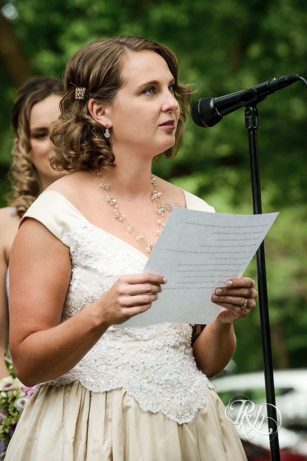 Bride and groom read vows during wedding ceremony at Summit Manor Reception House in Saint Paul, Minnesota.
