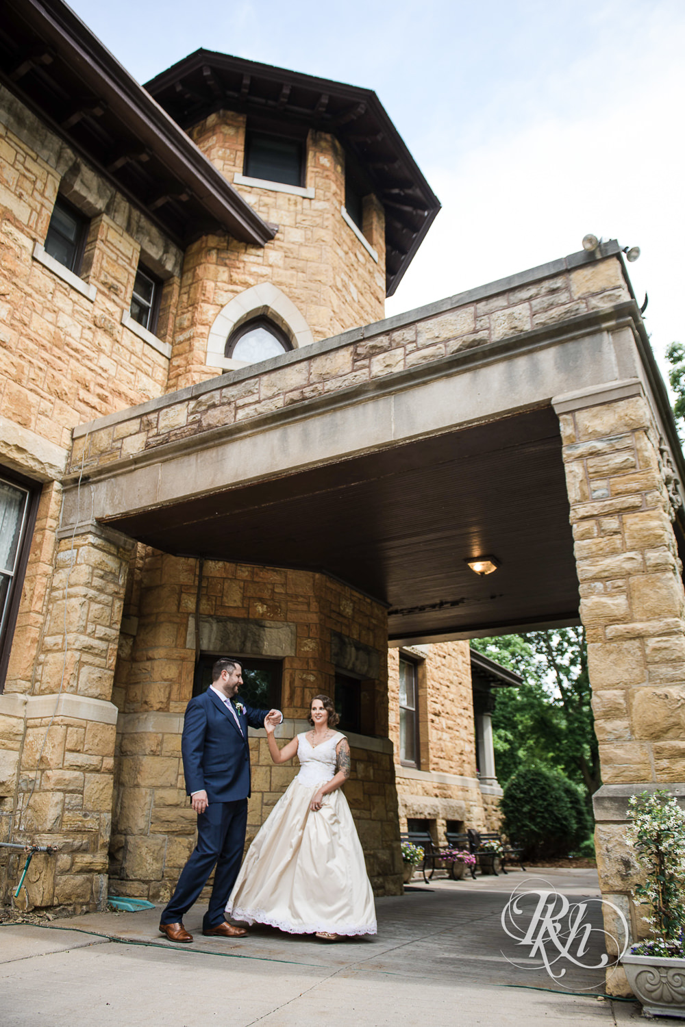 Bride and groom dance in front of Summit Manor Reception House in Saint Paul, Minnesota.