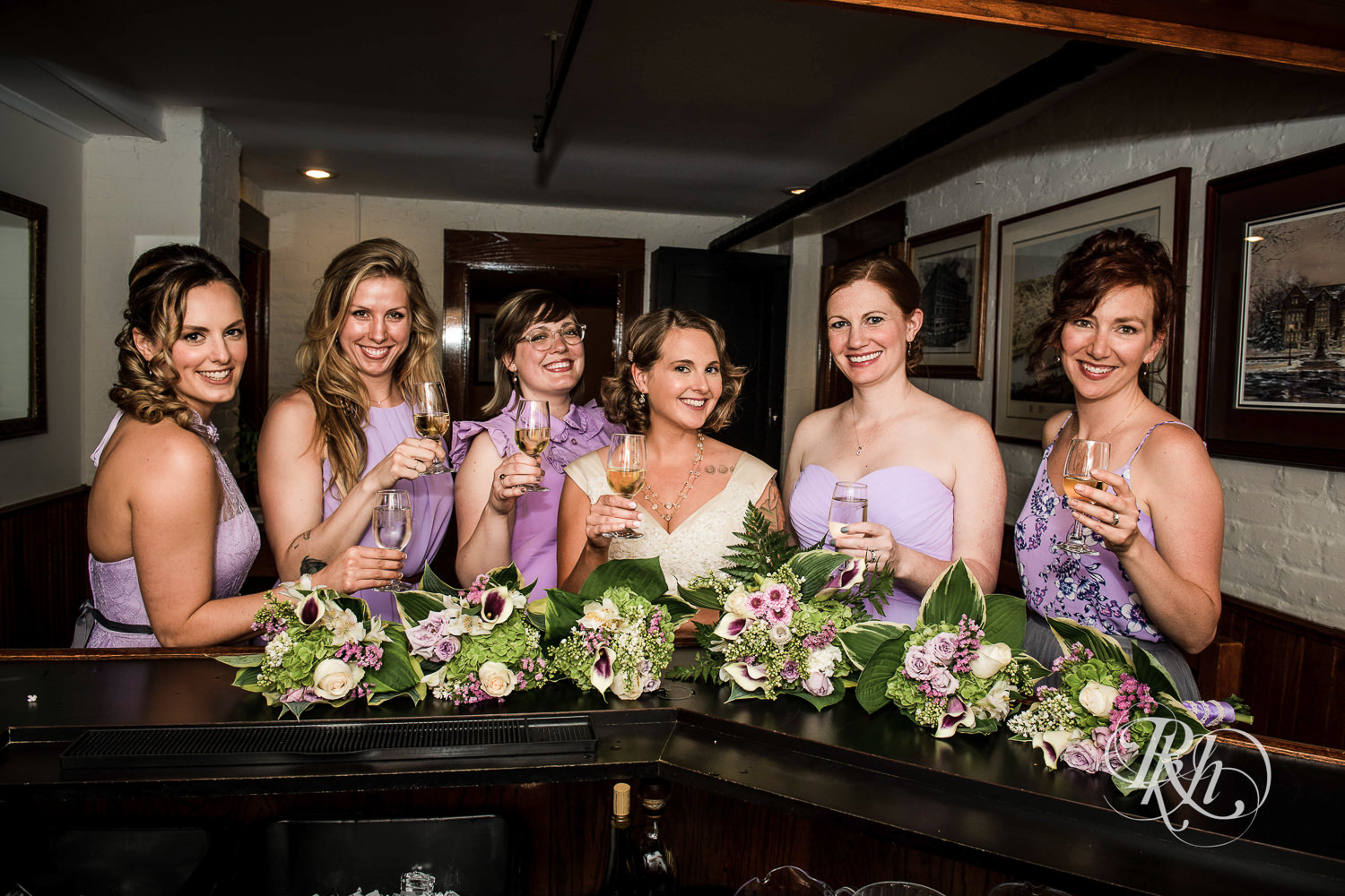 Wedding party smiles with drinks at Summit Manor Reception House in Saint Paul, Minnesota.