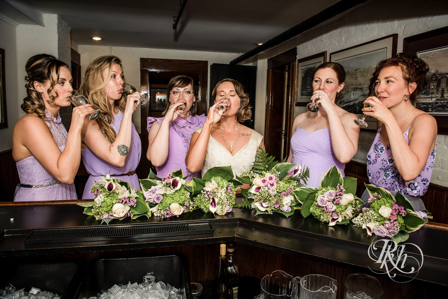 Wedding party smiles with drinks at Summit Manor Reception House in Saint Paul, Minnesota.