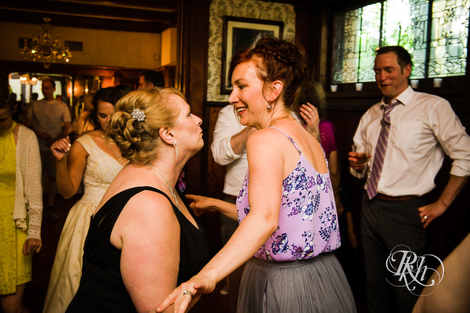 Guests dance during wedding reception at Summit Manor wedding in Saint Paul, Minnesota.