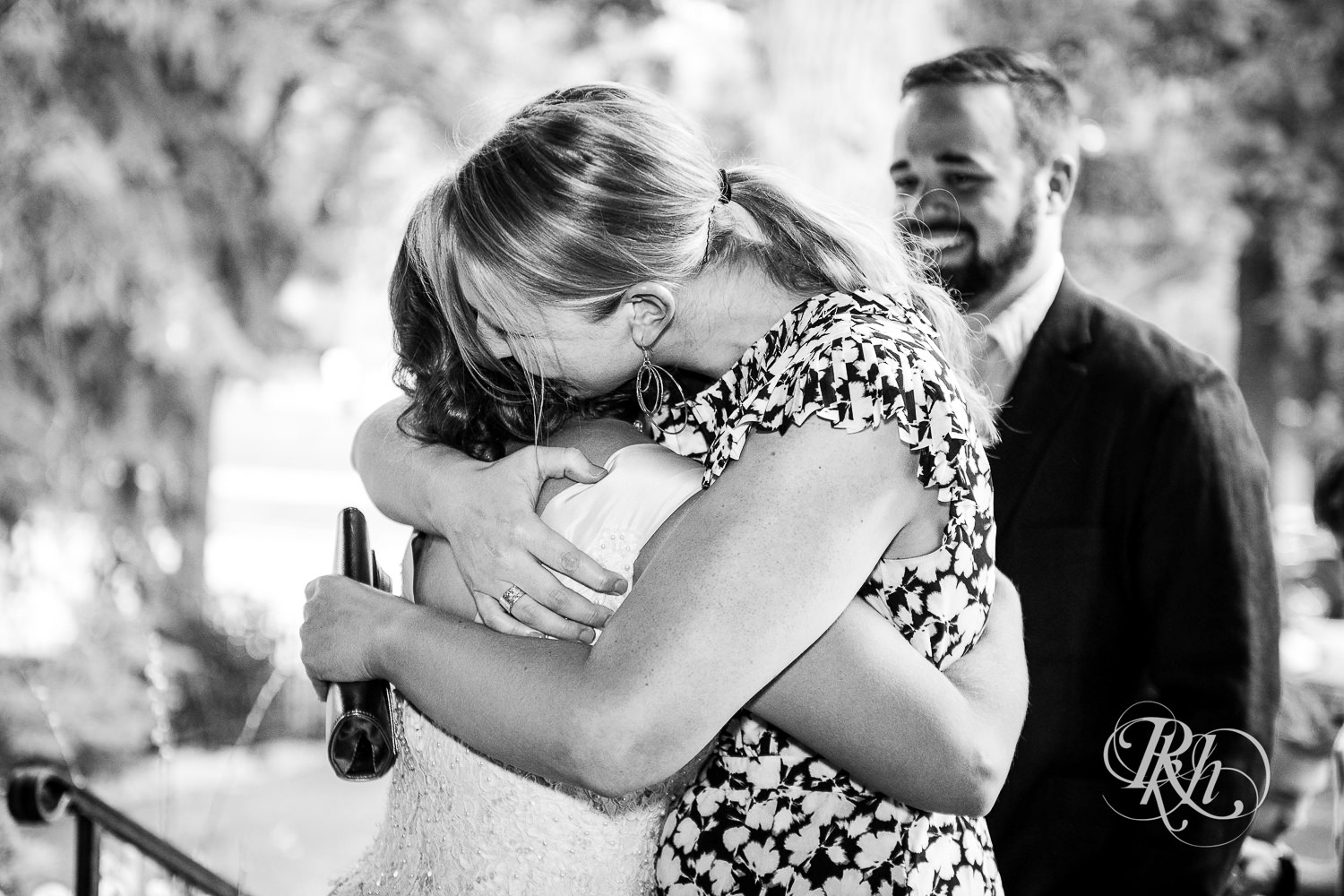 Guest hugs bride during wedding reception at Summit Manor wedding in Saint Paul, Minnesota.