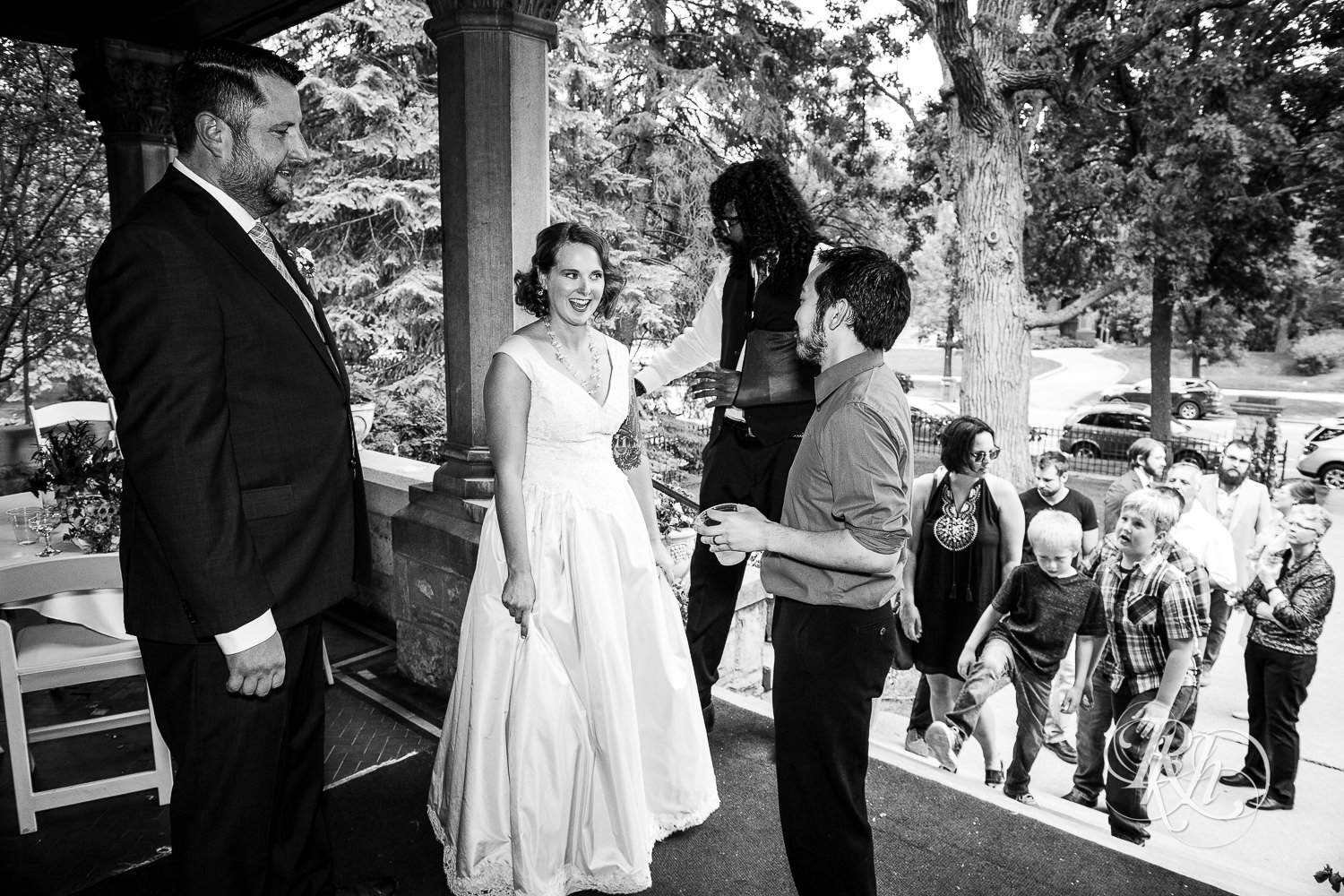 Guest hugs bride during wedding reception at Summit Manor wedding in Saint Paul, Minnesota.