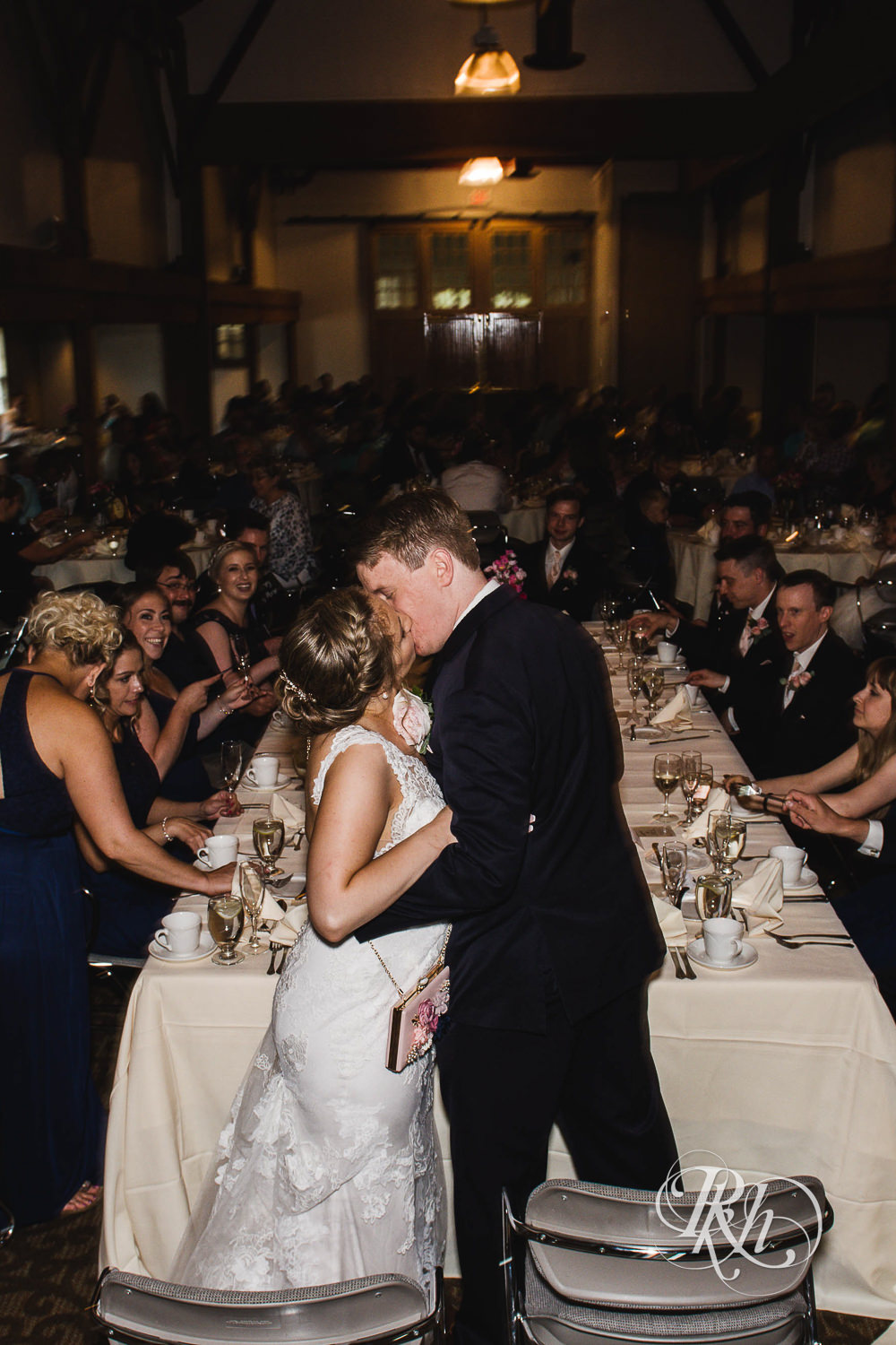 Bride and groom kiss during wedding reception at Earle Brown Heritage Center in Brooklyn Center, Minnesota.