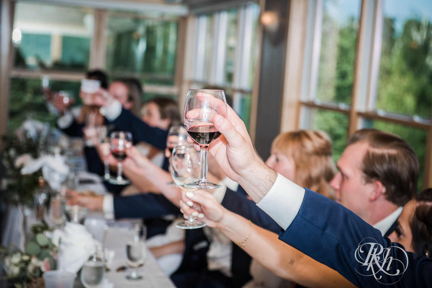 Guests toast during wedding reception during their Bluefin Bay wedding in Tofte, Minnesota.