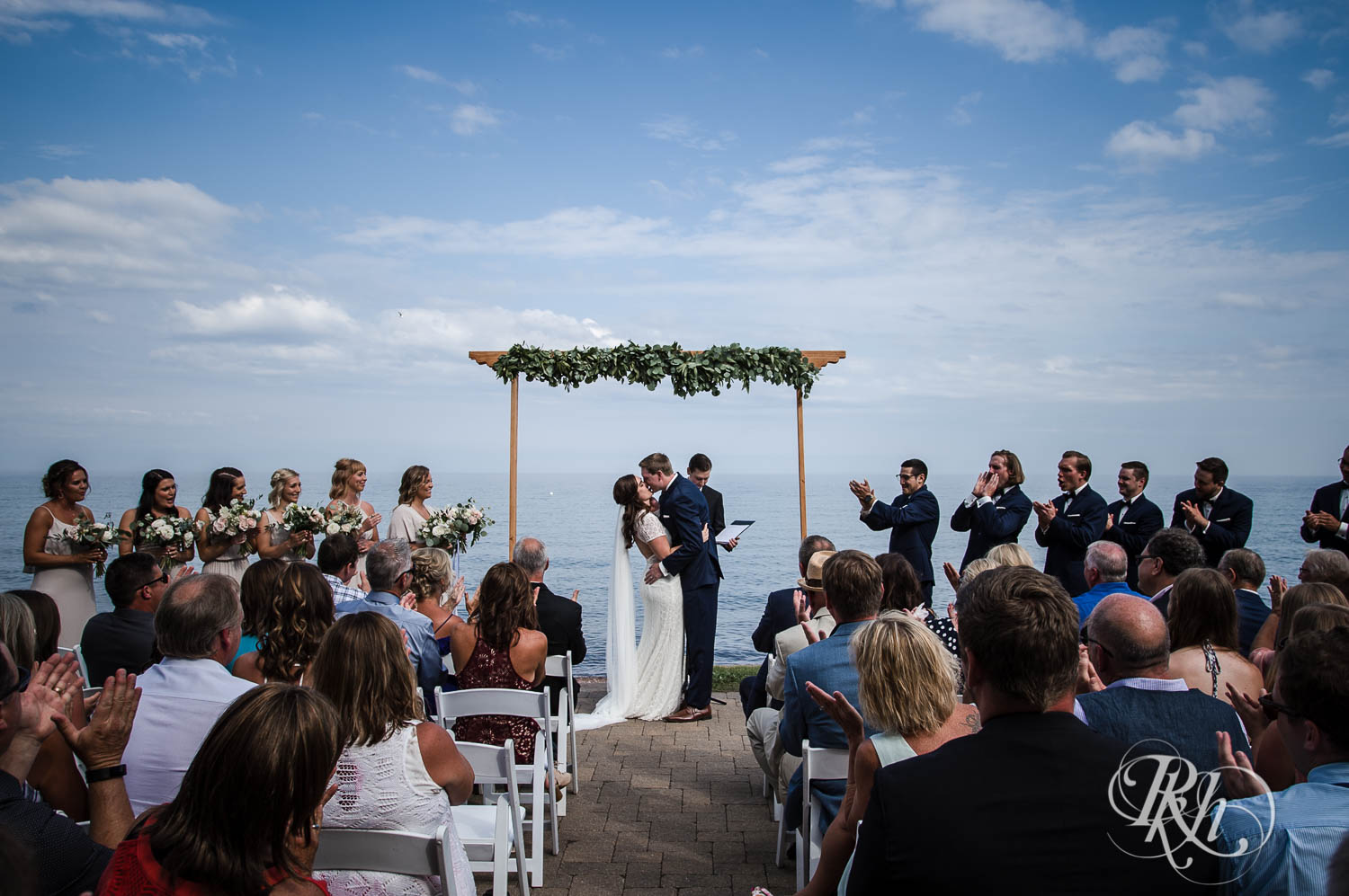 Bride and groom kiss during ceremony at their Bluefin Bay wedding in Tofte, Minnesota.